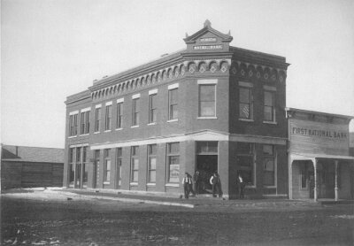 19xx The First National Bank of Shamrock with original bank beside it. With J. M. Shelton-President; Thomas B. Lee-VP; Oscar P. Jones-Cashier