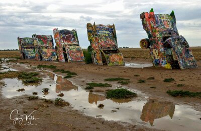 2001-08-11 Cadillac Ranch by Greg Vojtko ROUTE66 FF--Cars of Cadillac Ranch are seen here reflected in standing water after overnight rainstorm Sunday, August 12, 2001 west of Amarillo, TX. The ten...